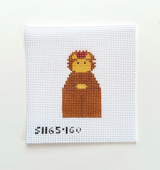 A square white needlepoint canvas featuring a pixelated cartoon character in brown, yellow, and red, with the black text 'SH65160' at the bottom, displayed against a plain off-white background.